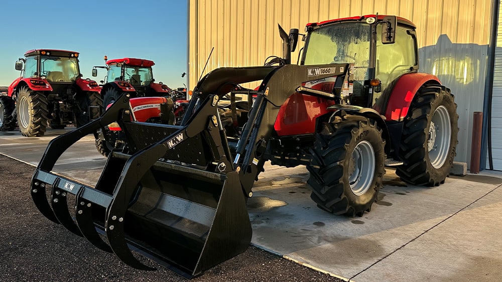 another angle of a Kubota tractor being showcased in a sunset
