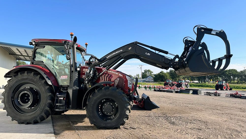 Kubota tractor with it's hay bale attachment raised